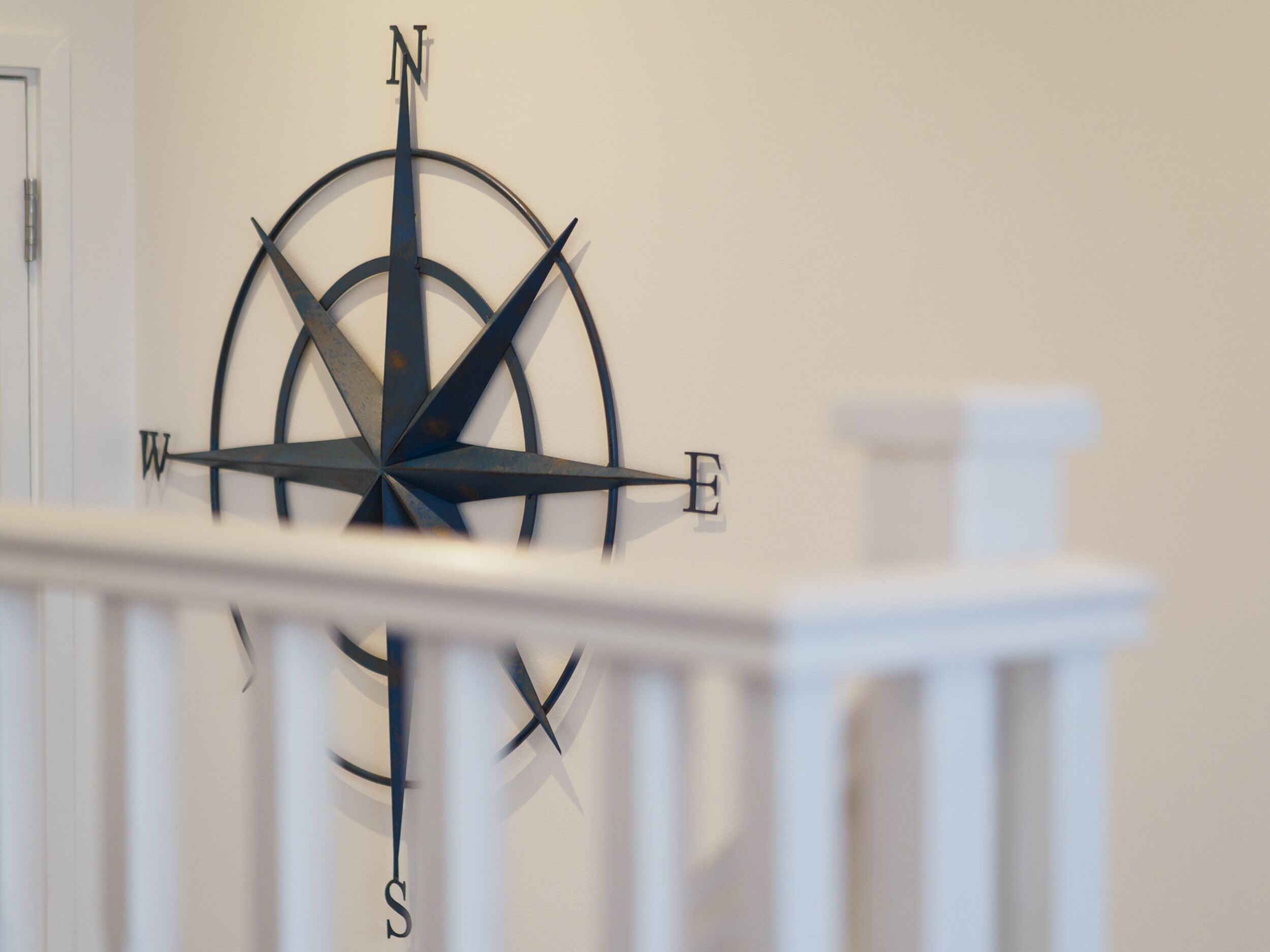 A compass mounted on a wall.
