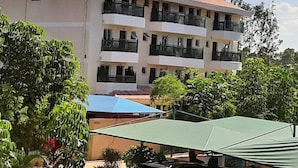 A multi-story building with balconies, surrounded by greenery. - Three Rivers Resort Maragua (Nairobi)