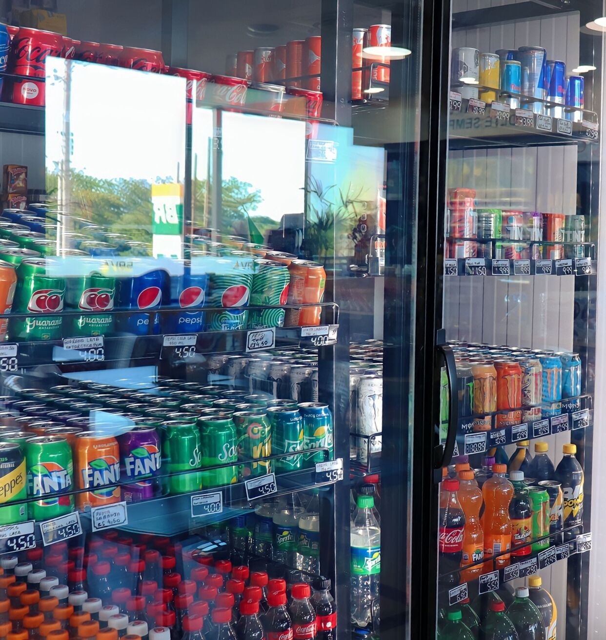A vending machine stocked with various beverages including sodas and energy drinks.