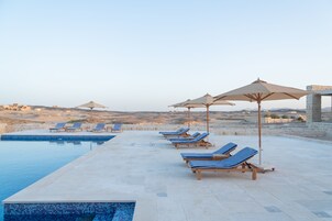 Outdoor pool, open 7:00 AM to 7:00 PM, pool umbrellas, sun loungers