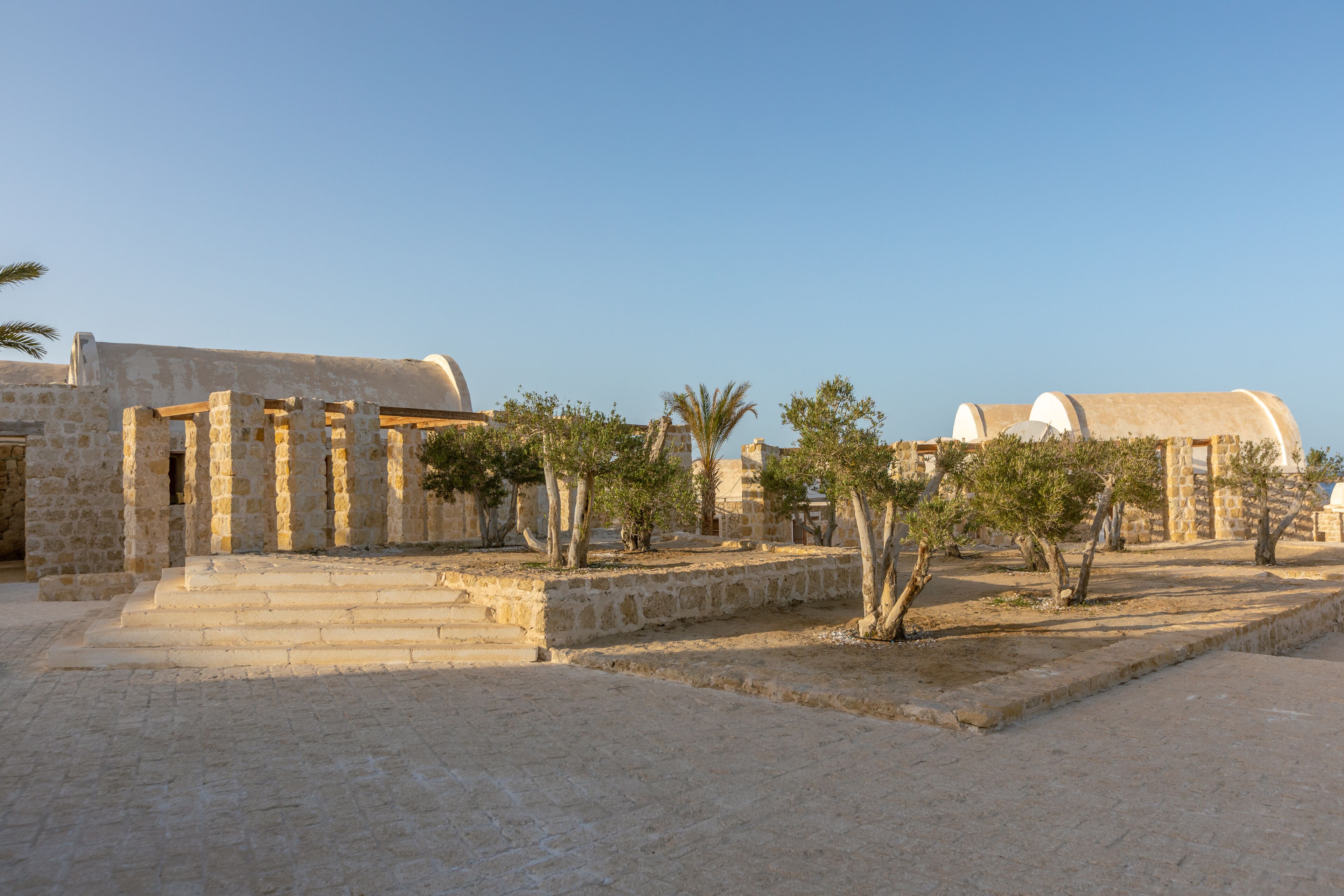 An ancient stone building with columns and a dome structure.