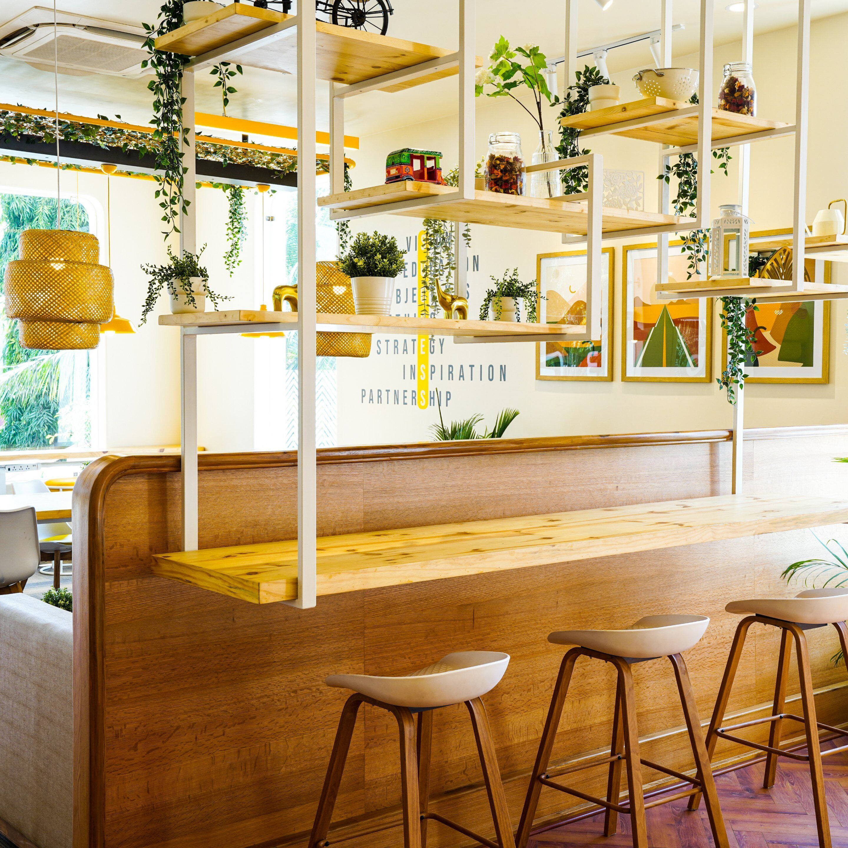 A modern bar area with wooden shelves, stools, and a bench.