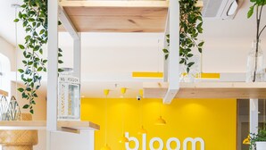 Un intérieur moderne avec un mur jaune sur lequel est inscrit le mot « bloom ».