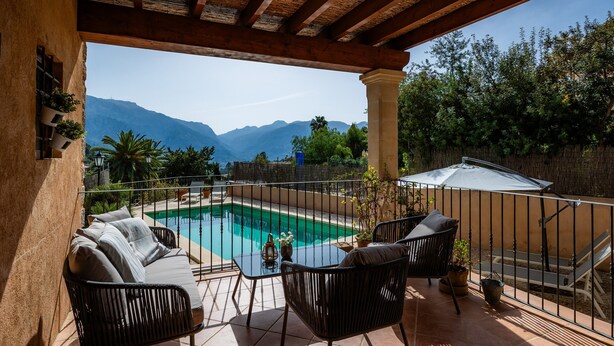 A terrace with a pool, outdoor furniture, and a view of mountains. - Holiday Home 'Can Bordoy' with Mountain View, Pool, Garden & Terrace (FORNALUTX)