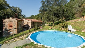 A stone building with a swimming pool, surrounded by greenery and a white chair. - Holiday Home "Mulino di Beboli" with Pool & Garden (Lamporecchio (PT))