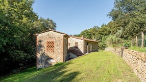 A stone building with a tiled roof, surrounded by a stone wall and lush greenery. - Holiday Home "Mulino di Beboli" with Pool & Garden (Lamporecchio (PT))
