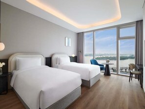 A hotel room with two beds, a dining area, and a large window with a view. - Hotel Naru Seoul - MGallery Collection (Seoul)