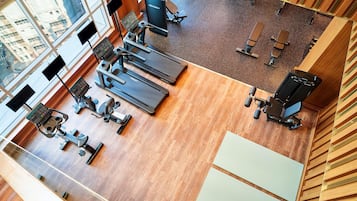 A gym with treadmills, exercise bikes, and weight machines.
