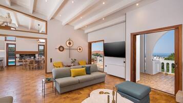 Family Villa | Living area | 65-inch Smart TV with satellite channels, TV, fireplace