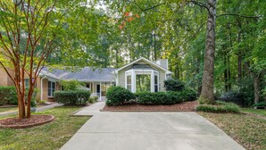A two-story house with a front yard, a driveway, and a large tree on the left. - Relaxing Home close the Battery/Mins to Everything (Smyrna)