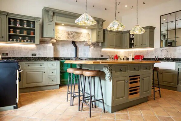 Enjoy cooking in this kitchen with a central island and pendant lights.