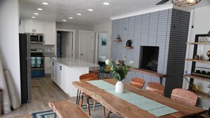 A modern kitchen with white cabinets, a built-in oven, and a microwave. - Updated 4-bedroom home centrally located in Logan (Logan)