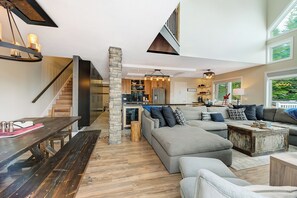 Relax in a spacious open-plan living space with a central seating area and kitchen.