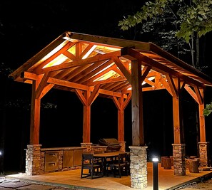 A wooden gazebo with a stone base and a grill area. - A mountain experience seen from above…a view that takes your breath away! (Jamestown)