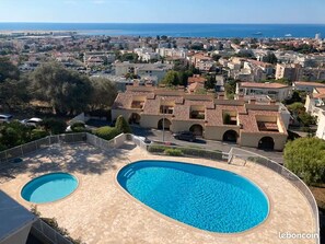 Enjoy a refreshing swim in the oval-shaped pool surrounded by a stone deck with a view of the sea.