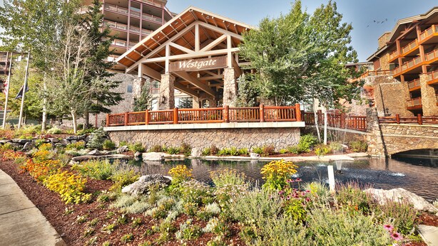 A Westgate building with a stone facade, wooden deck, and a sign.