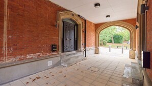 A brick building with a large arched doorway and a tiled entrance area. - The Woolwich Retreat - Enticing 5bdr House With Parking (London)