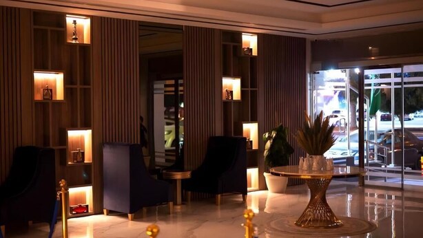 A lobby with a reception desk, seating area, and a large potted plant. - Ahlin 2 Serviced Apartment (Riyadh)