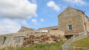 A stone building with a steeply pitched roof, a small window, and a staircase leading to the entrance. - Low Shipley Mill (Barnard Castle)