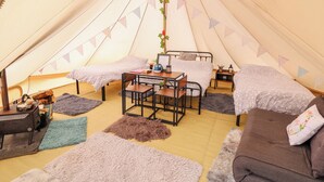 A cozy tent with two beds, a table, and a sofa. - Abercefel Retreat (Llandysul)