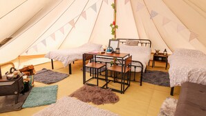 A cozy tented accommodation with two beds, a table, and a kettle. - Abercefel Retreat (Llandysul)