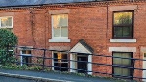 A red brick building with two windows, a small door, and a visible chimney. - 3 bedroom accommodation in Whatstandwell, near Matlock (Whatstandwell, near Matlock)