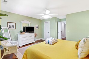 A bedroom with a bed, a dresser, a television, and a ceiling fan. - 3 Story Condo - Bonus Room Upstairs! (Hilton Head Island)