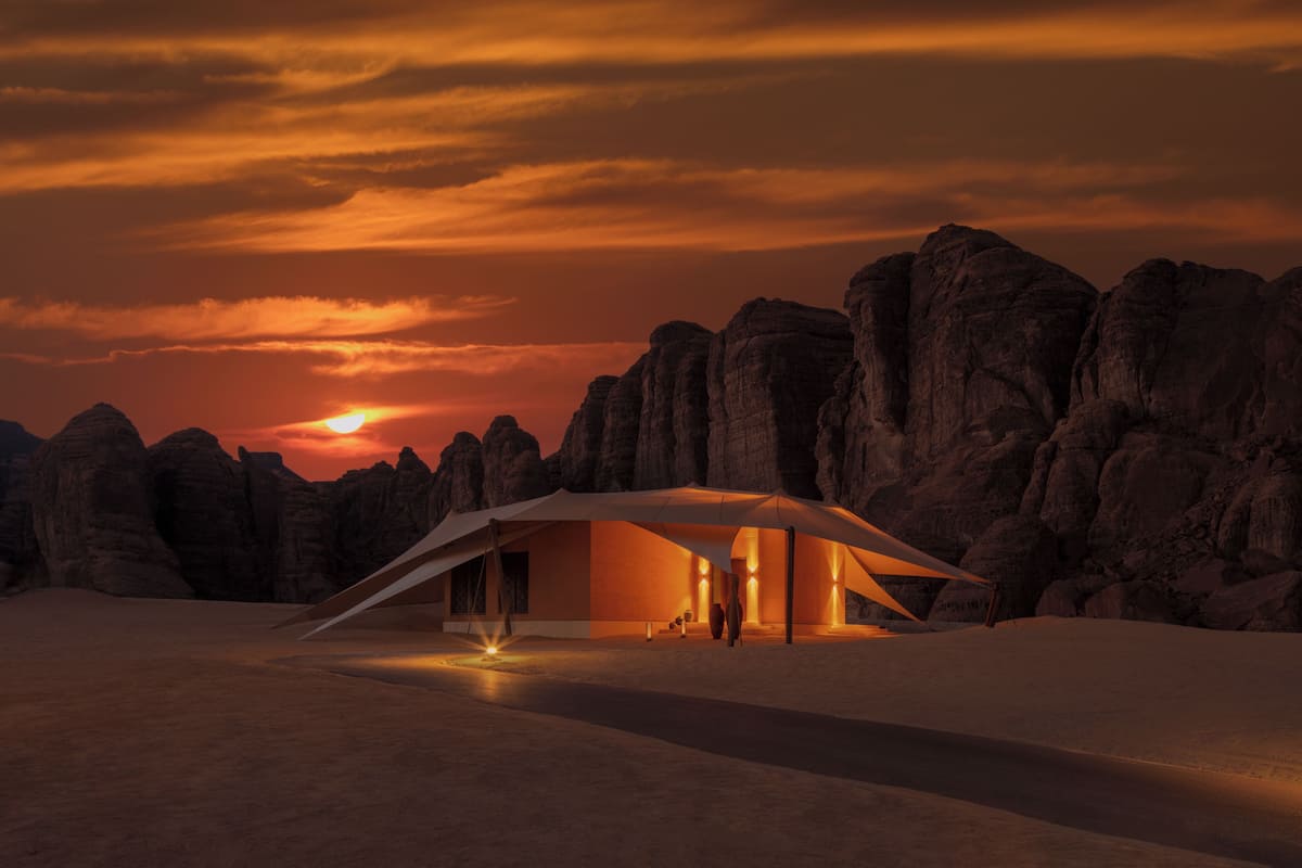 A desert hotel with a modern design, featuring a large, open interior space and a view of the surrounding rocky landscape.