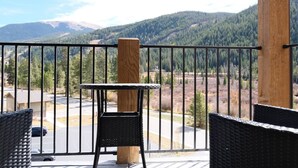 Ein Balkon mit Blick auf ein bewaldetes Tal und Berge.