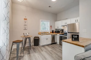 Enjoy cooking in this well-equipped kitchen with a refrigerator, microwave, and dishwasher, plus a convenient island with a sink and stools.