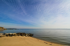 Enjoy a tranquil beach experience with a rocky shoreline and serene ocean views.