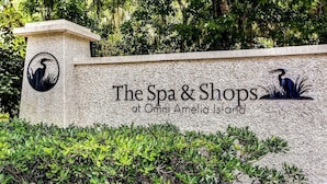A sign for The Spa & Shops at Omni Amelia Island, featuring a logo of a bird and text. - Oceanview 4BR condo in Amelia Island Plantation with pool, pet friendly! (Fernandina Beach)