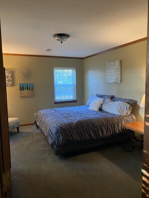 A bedroom with a bed, a window with blinds, a ceiling fan, and a small table. - Bucks Pocket State Park , Section Al. (Section)