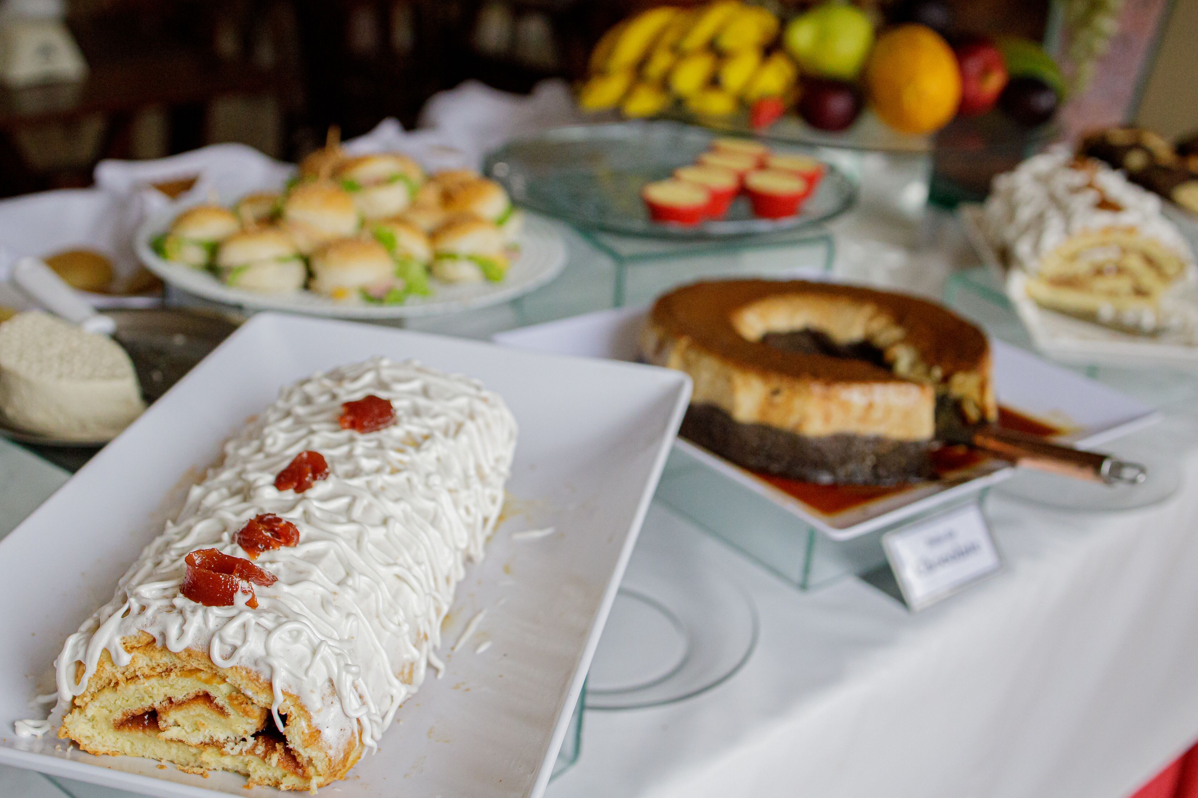 A buffet table with various desserts including a cake and pastries.