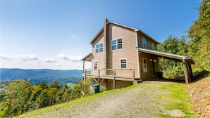 A two-story house with a balcony, a porch, and a view of the surrounding landscape. - Three-Level Cabin with Mountain Views (Boone)