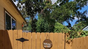 A wooden gate with a sign that reads "Welcome to our Home."