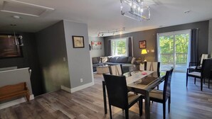 A modern living room with a dining area, a sofa, and a coffee table. - 2 Bedroom, 2 Bath Hot Tub home in the Galena Territory (Galena)
