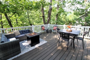 Large deck off the Kitchen with comfortable patio furniture and fire table