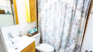 A bathroom with a white sink, wooden cabinet, and a toilet. - Studio In♥of DT Ft Lauderdale☆Walk 2 restaurants (Fort Lauderdale)