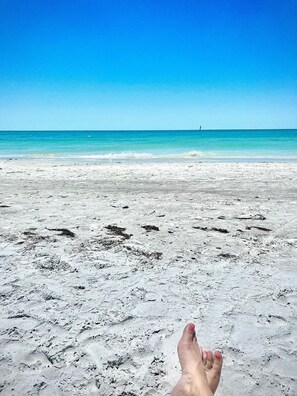 A beach with a clear sky and calm sea.