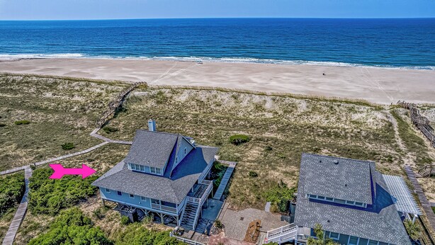 A coastal property with two main buildings, a wooden deck, and a beach view. - Ocean front home, access to both clubs and large porches! Breaking Point (Bald Head Island)