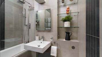 Bathtub, hair dryer, towels, soap