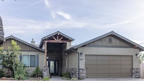 A modern two-story house with a garage, stone accents, and a covered entryway. - Picturesque Rosemary Retreat (California)