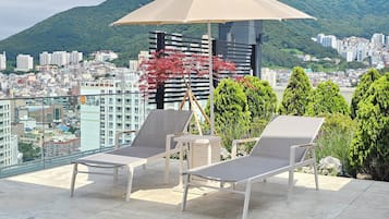 Outdoor pool, open 10:00 AM to 10:00 PM, pool umbrellas