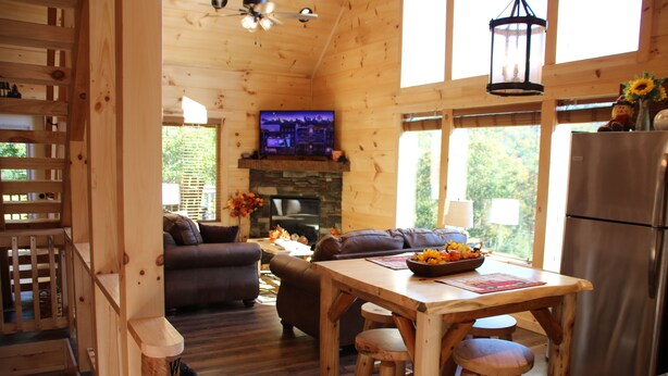 A wooden cabin interior with a living room, dining area, and kitchen. - Amazing MTN Views/Location, Minutes to Gatlinburg, Hot Tub, Pool Table, WIFI (Gatlinburg)