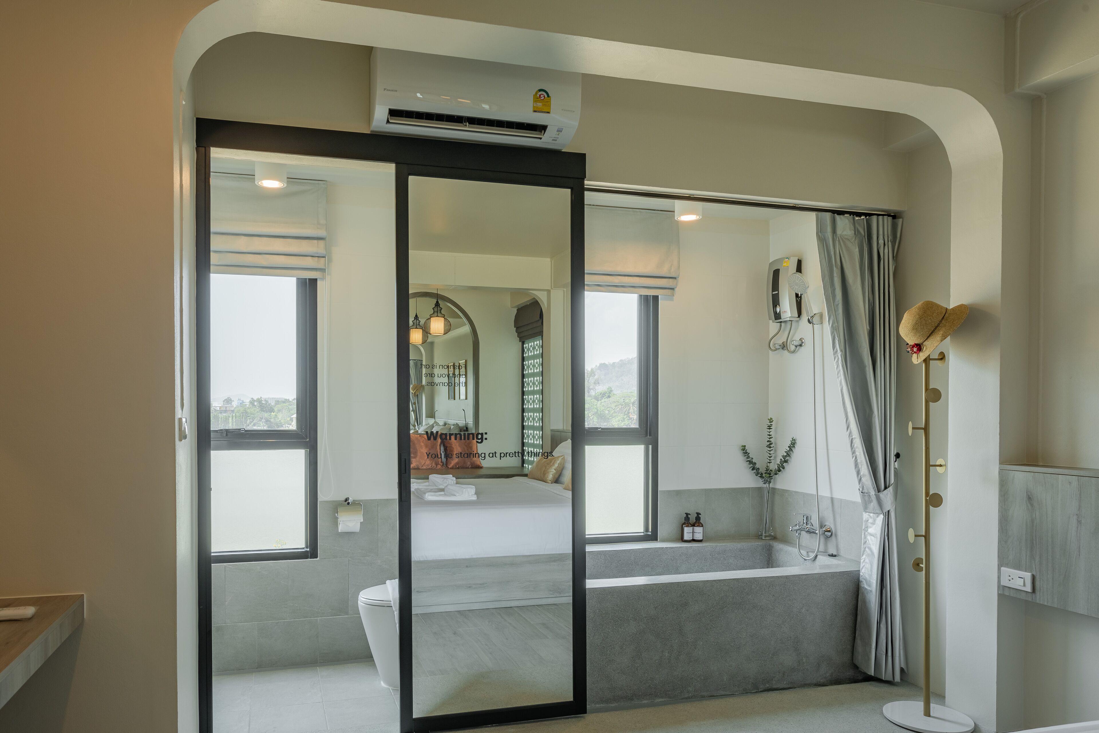 A modern bathroom with a glass shower enclosure, a bathtub, and a vanity with a mirror.
