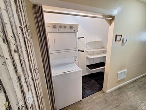 A compact kitchen with a built-in oven and microwave, a small pantry, and a black mat on the floor. - Newly Updated 2BR w/loft 3BA Family Ski Basecamp 568 (Mammoth Lakes)