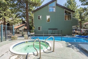 A swimming pool area with a hot tub, a covered seating area, and a house in the background. - Newly Updated 2BR w/loft 3BA Family Ski Basecamp 568 (Mammoth Lakes)