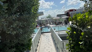 A pathway leading to a pool area with a clear sky and some clouds. - Lovely waterfront condo (Hollywood)