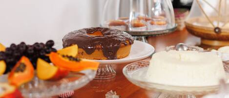 A table with various desserts and fruits.